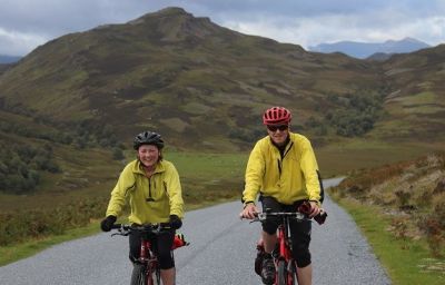 Shirley and Trevor Acreman Cycling on the  tour with redspokes